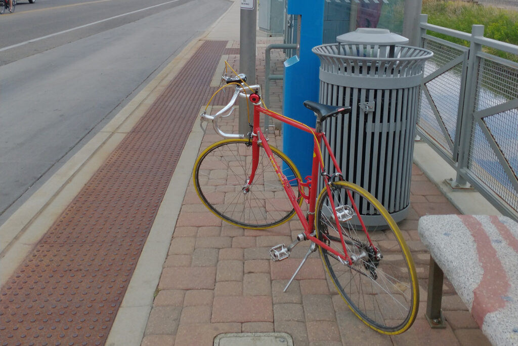 My road bike "Le Royale with Cheese" at a bust stop in Fort Collins, CO.